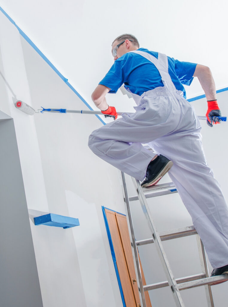 Professional painter painting high ceiling in Mississauga home