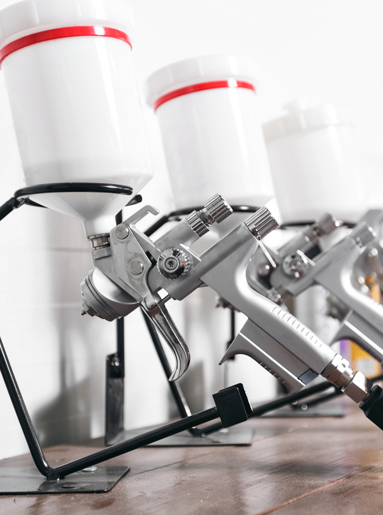 Professional industrial paint spray guns prepared for coating application