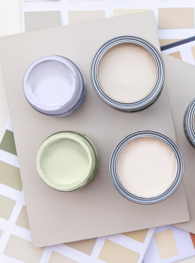 Open paint cans with neutral color samples for interior painting in Hamilton