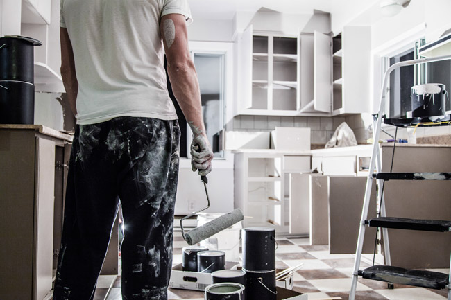 Professional painter preparing for industrial painting project in a modern workspace