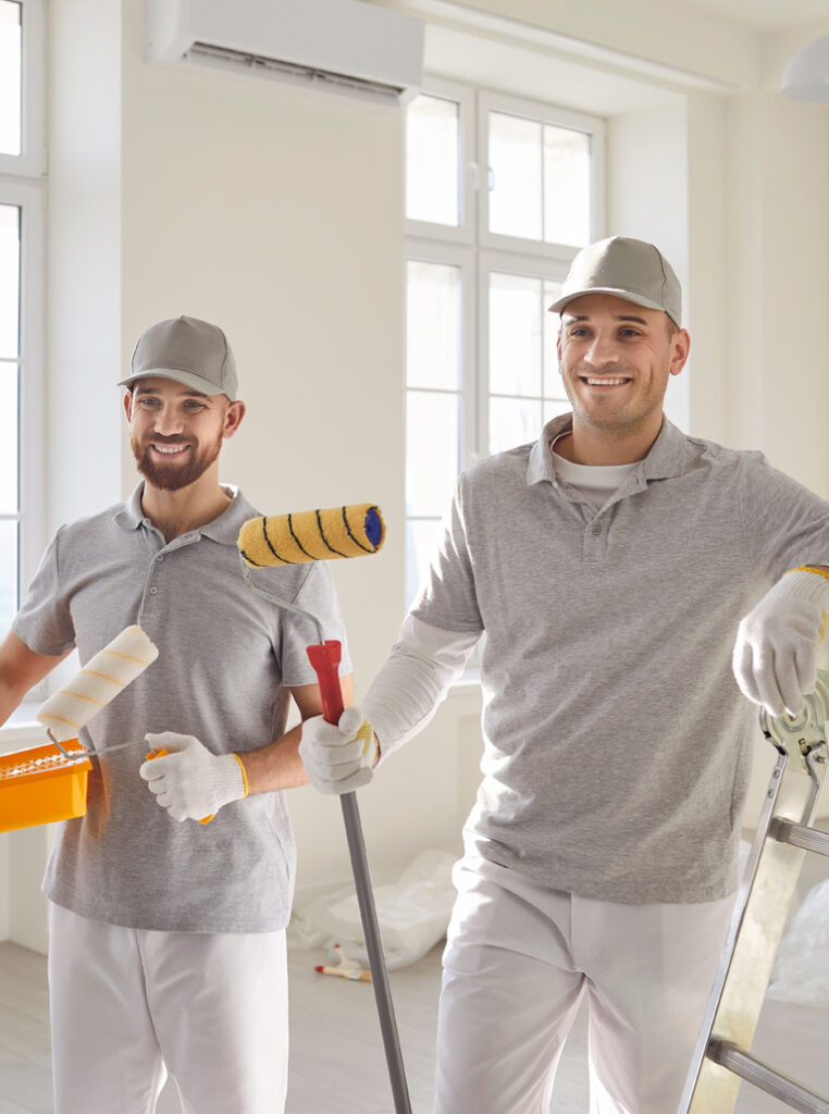 Professional painters in Hamilton standing with rollers ready for interior painting