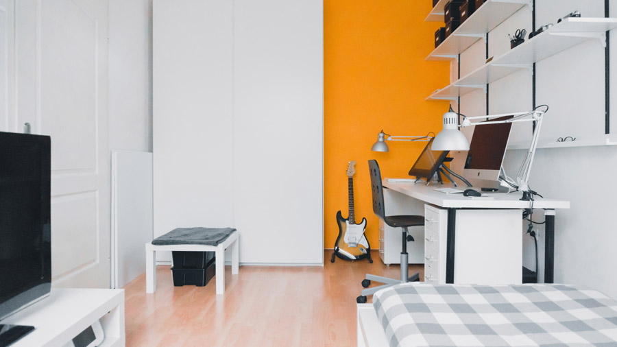 Modern home office interior with orange accent wall after color consultation