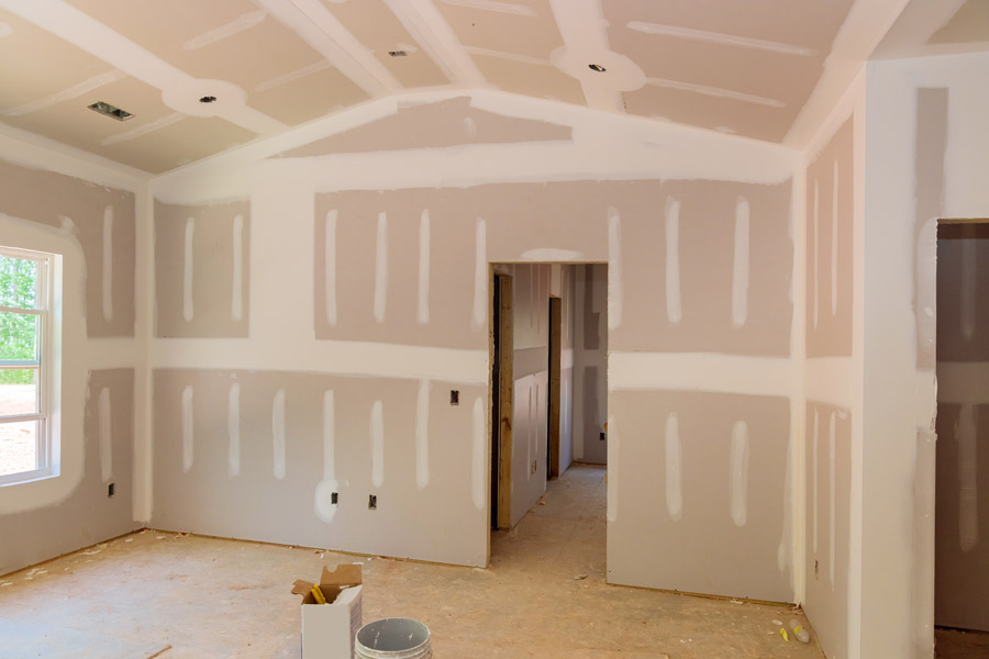 Drywall installation and taping process before painting interior walls