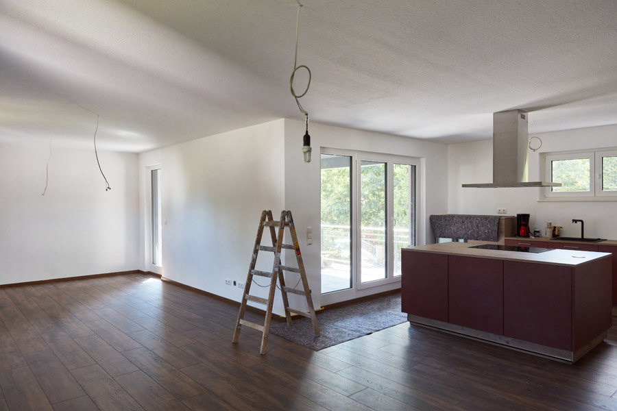 Freshly painted drywall interior with clean white walls and modern kitchen renovation