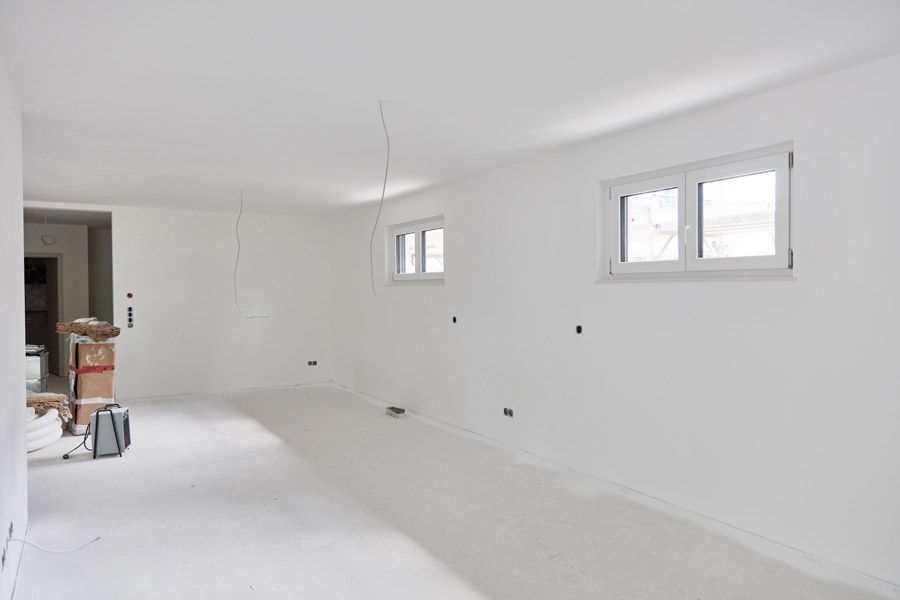 Freshly repaired and painted drywall in modern white interior space