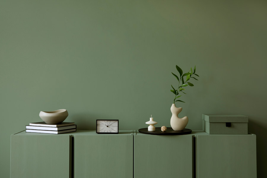 Minimalist interior with olive green eco-friendly painted wall and modern decor