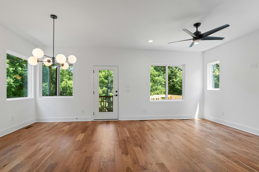 Bright modern living room with white eco-friendly painted walls and wooden flooring