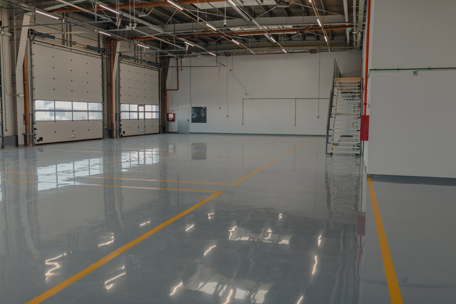 Epoxy floor coating Toronto — glossy gray industrial floor by Walls Master