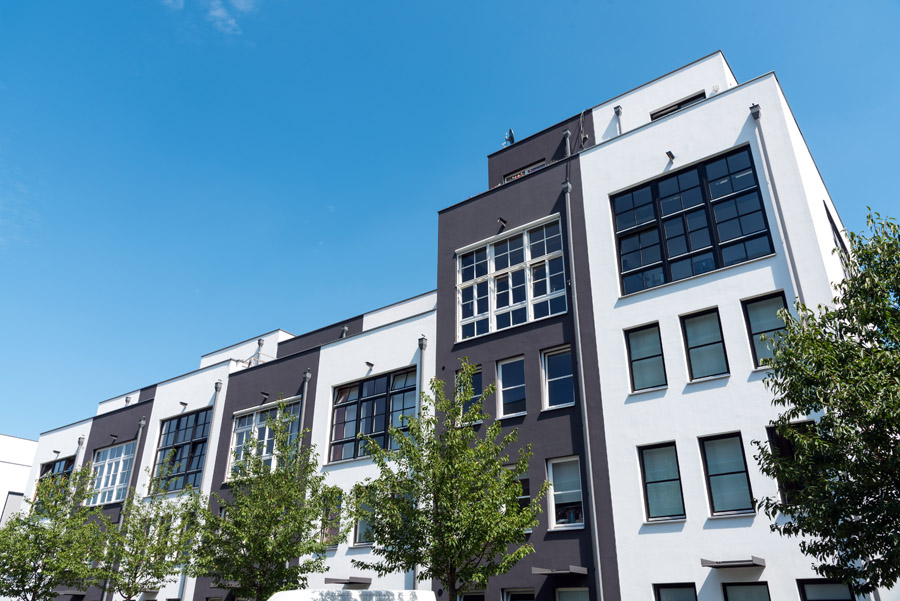 Condo building exterior painting Toronto — modern black and white facade repainted by Walls Master