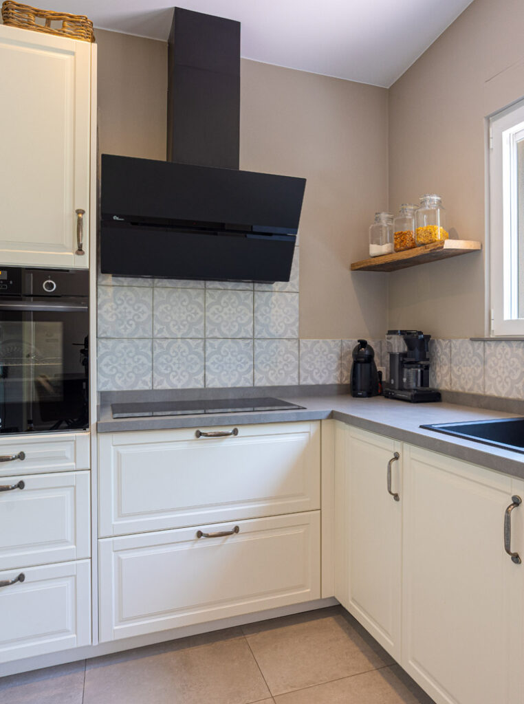 Modern kitchen in Toronto with matte white painted cabinets and black range hood