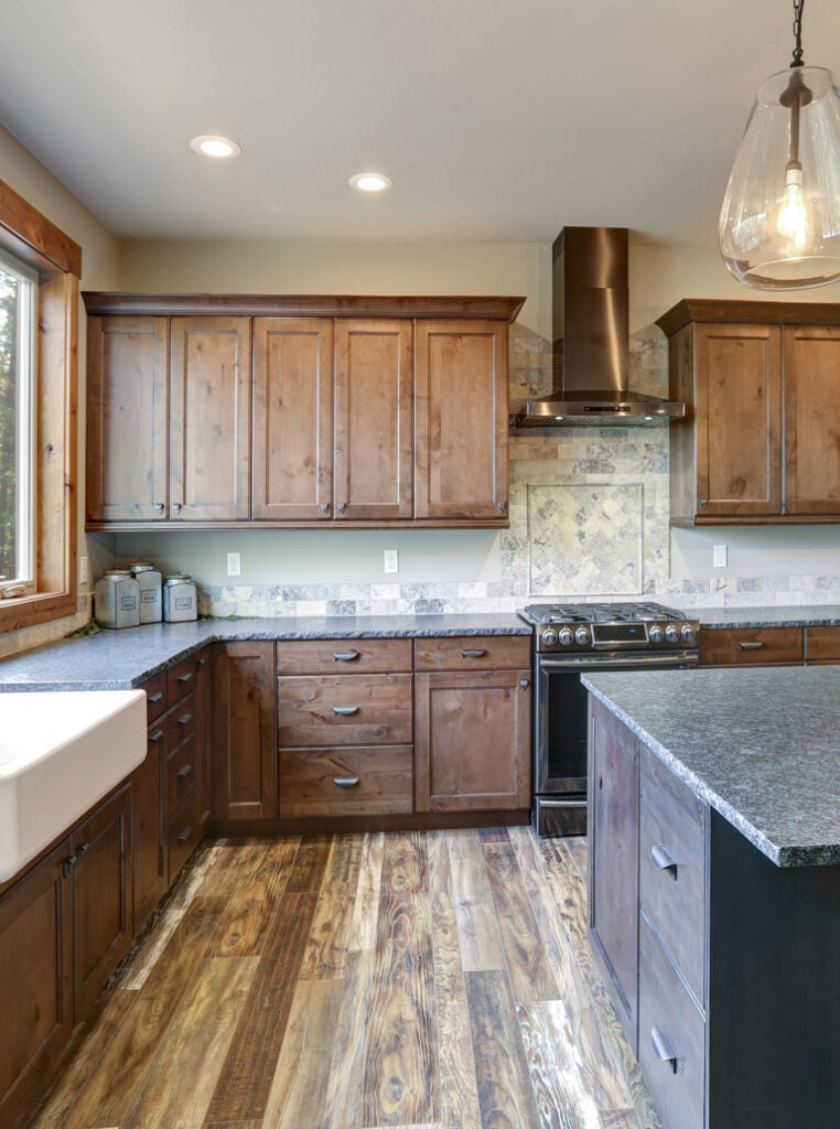 Modern kitchen in Toronto with refinished walnut wood cabinets and granite countertops